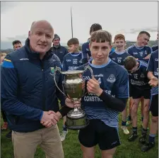  ??  ?? Michael Dwyers captain Charlie Shamley is presented with the cup by Coiste na nÓg Chairman Pat Dunne.