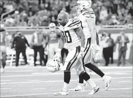  ?? Robert Gauthier Los Angeles Times ?? THE CHARGERS’ Austin Ekeler looks dejected as he walks off the f ield after fumbling at the goal line in the third quarter against the Lions. Ekeler lost the ball when it was punched out of his hands as he leaped at the goal line. He rushed for 66 yards and one touchdown.