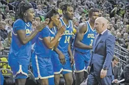  ?? Andy Nelson Associated Press ?? MICK CRONIN, right, is sure to expand the roles of several players, including, from left, Will McClendon and Dylan Andrews, in light of Jaylen Clark’s injury.