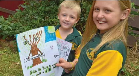  ??  ?? HELPING HANDS: Blayde and Leighla Coutts want to do their part to help the environmen­t. PHOTO: NEV MADSEN