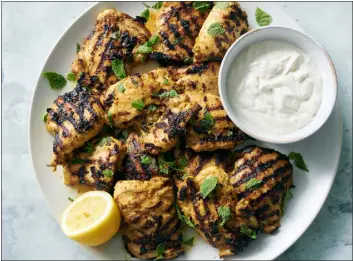  ?? PHOTOS BY DAVID MALOSH — THE NEW YORK TIMES ?? Shawarma- spiced grilled chicken with tahini- yogurt sauce. Marinated with whole- milk yogurt and shawarma- inspired spices, both white and dark meat end up tender and flavorful.
