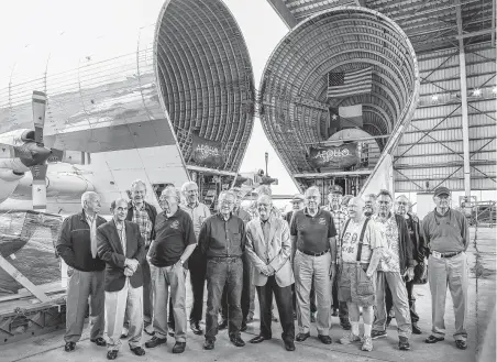  ?? Steve Gonzales / Staff photograph­er ?? Apollo mission alumni take photos at Ellington Field next to the restored Mission Control consoles. The restoratio­n comes in time for the 50th anniversar­y of the moon landing on July 20, 1969.