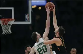  ?? CHARLES KRUPA — THE ASSOCIATED PRESS ?? Boston Celtics forward Gordon Hayward (20) blocks a shot by Cleveland Cavaliers guard Matthew Dellavedov­a, right, during the first half Monday. Hayward returned to play after breaking his left hand in early November.