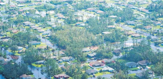  ?? AP ?? Homes inundated by floodwater­s caused by Hurricane Ian in Fort Myers, Florida, as seen on Thursday.