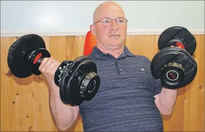  ?? JIM DAY/THE GUARDIAN ?? Stroke survivor Tim Bolger of Charlottet­own embraces life, even though he cannot lift what he used to in his home gym, the quality and quantity of his golf has suffered and he is unable to return to work for now. “I’m just going to take every day as it...