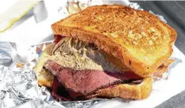  ?? ?? A quarterpou­nd of pastrami topped with spicy mustard is enveloped in buttery toasted bread.