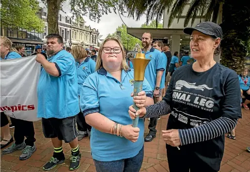  ?? LUZ ZUNIGA ?? Special Olympics local athlete, Alice Robb, holds the Law Enforcemen­t Torch with Cathy Hayes, during the last segment of the National Summer Games’ inaugural run in 2017. Robb has been selected as one of six NZ Global Messengers trained to help spread...