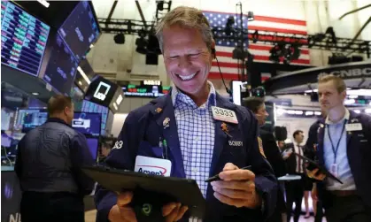  ?? ?? Traders on the New York Stock Exchange: the S&P 500 gained 25% in 2023. Photograph: Andrew Kelly/Reuters