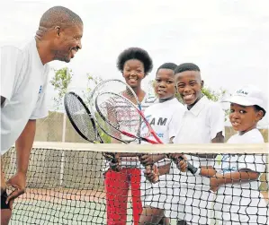 ?? Picture: FREDLIN ADRIAAN ?? ON THE BALL: Mbulelo Lugogwana puts a few pupils on his developmen­t programme through their paces at the Zwide Stadium as they prepare for the tournament later this month. Pictured from left with Lugogwana are Masego Bokaba, 12, Sisekele Ngqwala, 12,...
