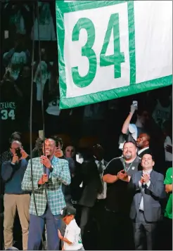  ?? MICHAEL DWYER/AP PHOTO ?? Former Boston Celtic Paul Pierce, left, raises a banner during a ceremony to retire his number following Sunday’s game against the Cavaliers at Boston.