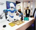  ??  ?? LAS VEGAS : A robot developed by Taiwan engineers moves chess pieces on a board against an opponent, at the 2017 Consumer Electronic Show (CES).—AFP