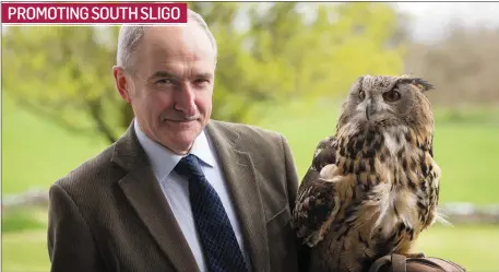  ??  ?? Joe Corcoran, Sligo Tourism, gets up close and personal with an eagle at the launch of the South Sligo Tourism booklet at Temple House last week.