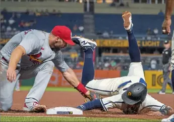  ?? Associated Press ?? Cardinals first baseman Paul Goldschmid­t, left, reaches to tag Pirates baserunner Michael Chavis as Chavis dives back to first on a pickoff attempt from catcher Yadier Molina.