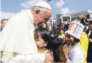  ?? Andrew Medichini / Associated Press ?? Pope Francis greets children upon his arrival in Yangon, Myanmar. He will also visit Bangladesh.