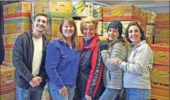  ?? NICK SMIRNOFF / FOR TEHACHAPI NEWS ?? Prior to masking up and loading up family food boxes are volunteer members of the Platinum Realty Group, from left to right: Carson Wolff, Shannon Daffern, Christy Rabe, Salvation Army Area Director Sandy Chavez and Platinum Realty member Lisa Mackenzie.