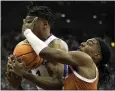  ?? CHARLIE RIEDEL — THE ASSOCIATED PRESS ?? Kansas' Joseph Yesufu, left, beats Texas' Marcus Carr to a rebound in Saturday's Big 12 title game.