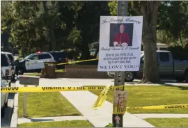  ?? DAMIAN DOVARGANES — THE ASSOCIATED PRESS ?? An image of Bishop David O'Connell is posted on the post of a street sign near his home in Hacienda Heights on Sunday. O'Connell was shot and killed Saturday. Carlos Medina, the husband of O'Connell's housekeepe­r, has been accused of shooting O'Connell to death.