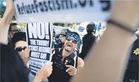  ?? Photograph­s by Wally Skalij Los Angeles Times ?? AMID a heavy police presence, demonstrat­ors engage in a shouting match before Milo Yiannopoul­os’ appearance at UC Berkeley.