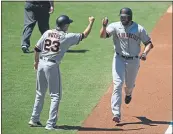  ??  ?? The Giants’ Darin Ruf is congratula­ted by Ron Wotus after hitting a two-run home run during the second inning against the Padres on Wednesday in San Diego.