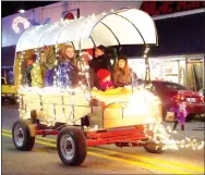  ?? Photo by Randy Moll ?? This well-lit covered wagon was a part of the annual Gentry Chamber of Commerce Christmas Parade on Saturday.