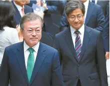  ?? Yonhap ?? President Moon Jae-in walks ahead of Supreme Court Chief Justice Kim Myeong-su at a ceremony held at the Supreme Court in southern Seoul, Thursday, to mark the 70th anniversar­y of the country’s establishm­ent of its judicial system.