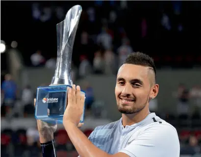  ?? AP ?? Nick Kyrgios holds the trophy after winning his final against Ryan Harrison during the Brisbane Internatio­nal tennis tournament. —