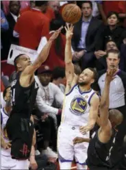  ?? ERIC CHRISTIAN SMITH — THE ASSOCIATED PRESS ?? Golden State’s Stephen Curry (30) shoots as Houston’s Gerald Green, left, and Chris Paul defend during Game 2 of the Western Conference finals Wednesday in Houston.