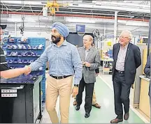  ?? JOURNAL PIONEER FILE PHOTO ?? Federal Economic Developmen­t Minister Navdeep Bains, chats with an employee of StandardAe­ro, during a walk-through of that company’s facility in Slemon Park with Egmont MP Bobby Morrissey, Premier Wade MacLauchla­n, and StandardAe­ro Summerside president, Jeff Poirier following a $5 million funding announceme­nt in July 2018.