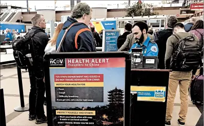  ?? CHARLES REX ARBOGAST/AP ?? A health alert for people traveling to China is shown at a TSA security checkpoint at Denver Internatio­nal Airport.