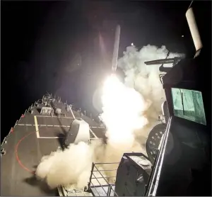  ?? AP/ U. S. Navy/ SPECIALIST 3RD CLASS ROBERT S. PRICE ?? The USS Ross fires a Tomahawk missile early today from the Mediterran­ean Sea in this image provided by the U. S. Navy. The Ross and the USS Porter fi red more than 50 missiles at a Syrian air base from which U. S. officials say Syrian planes took off...