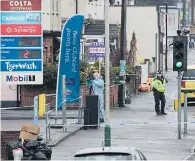  ??  ?? Police and forensics officers at the scene yesterday