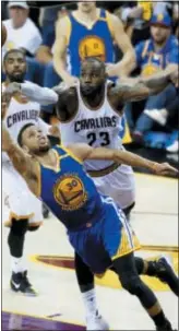  ?? RON SCHWANE — THE ASSOCIATED PRESS FILE ?? In this file photo, Golden State Warriors guard Stephen Curry (30) shoots in front of Cleveland Cavaliers forward LeBron James (23) during the second half of Game 3 of basketball’s NBA Finals in Cleveland. Game 1 of the 2018 NBA Finals between the...