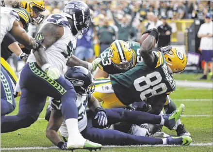  ?? MIKE ROEMER / ASSOCIATED PRESS ?? Ty Montgomery scores on a 6-yard run in the third quarter as Green Bay takes a 7-3 lead. The touchdown came one play after Green Bay defensive lineman Mike Daniels strip sacked Seattle quarterbac­k Russell Wilson deep in Seahawks territory.