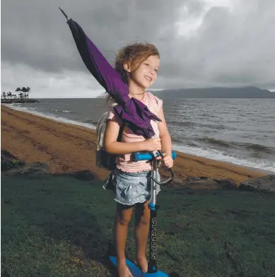  ??  ?? Sienna Tomarchio, 5, is prepared for wet weather in Townsville. Picture: Evan Morgan