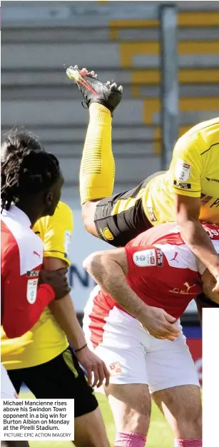  ?? PICTURE: EPIC ACTION IMAGERY ?? Michael Mancienne rises above his Swindon Town opponent in a big win for Burton Albion on Monday at the Pirelli Stadium.