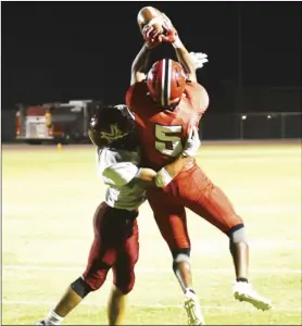  ?? PHOTO AARON BODUS ?? Going up! Imperial’s Joey Ramos wins a jump ball in one-onone coverage in a game vs. the Monte Vista Monarchs on Friday. Ramos made big plays for the Tigers all night long in a 26-25 win.