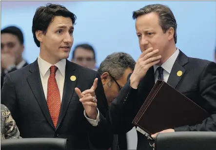  ?? — CP ?? Prime Minister Justin Trudeau talks to British Prime Minister David Cameron during the G20 summit in Antalya, Turkey, on Sunday. Trudeau has said little about the Paris attacks since Friday.