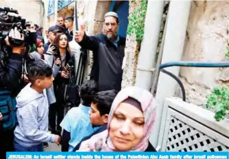  ?? — AFP ?? JERUSALEM: An Israeli settler stands inside the house of the Palestinia­n Abu Asab family after Israeli policemen evicted them from the house they lived in for decades, in the Old City of Jerusalem yesterday.