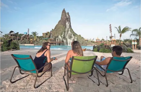  ?? PHOTOS BY UNIVERSAL ORLANDO RESORT ?? At 200 feet, Universal’s Krakatau Volcano towers over its competitor­s and is an imposing sight. Waterfalls cascade down the mountain and feed the Waturi Beach wave pool at the base of the volcano.