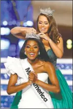  ?? The Associated Press ?? WINNER: Miss New York Nia Franklin reacts after being named Miss America 2019, as she is crowned by last year’s winner Cara Mund on Sunday in Atlantic City, N.J.