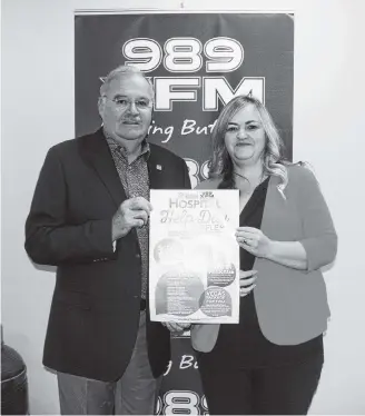  ?? Richard Mackenzie ?? 989 XFM general manager Ken Farrell and St. Martha’s Regional Hospital Foundation executive director Sadie Benoit with the promotiona­l poster for this year’s 989 XFM Hospital Help Day Raffle which will take place Oct. 24 at Antigonish Market Square.