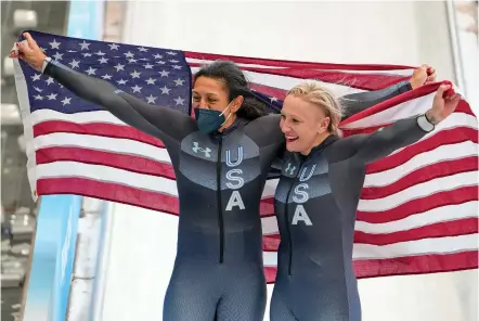  ?? PAVEL GOLOVKIN/ASSOCIATED PRESS ?? Kaillie Humphries of the United States, right, and teammate Elana Meyers Taylor celebrate winning the gold and silver medals in the women’s monobob at the 2022 Winter Olympics on Sunday in the Yanqing district of Beijing.
