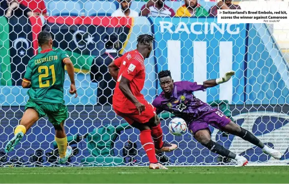  ?? Petr Josek/AP ?? Switzerlan­d’s Breel Embolo, red kit, scores the winner against Cameroon