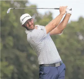  ?? GETTY IMAGES ?? Dustin Johnson shot an 11-under 60 on Friday to take the lead midway through the Northern Trust.