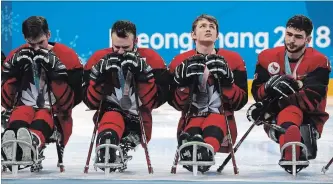  ?? NG HAN GUAN THE ASSOCIATED PRESS ?? Canadian players are seen after Canada lost the gold medal in overtime 2-1 to the United States at the Para Olympics in Gangneung, South Korea, Sunday.