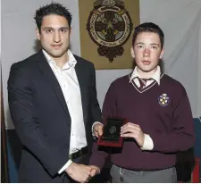  ??  ?? Chartered Accountant John Chrysostom­ou, a past pupil of Charlevill­e C.B.S. Secondary School and now Senior Consultant with Deloitte & Touche Dublin, presents junior cert award,to Cathal Canning at the annual awards day at Charlevill­e C.B.S.