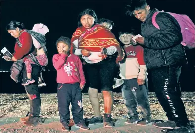  ?? ?? ROAD TO YUMA: Migrants at the border near Yuma, Ariz., a town of 100,000 that sees 6,000 new entries weekly.