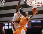  ?? Brynn Anderson / AP ?? Alabama’s Donta Hall (left) defends against Tennessee’s Lamonte Turner during the first half of Saturday’s game.