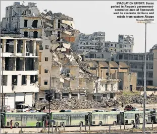  ?? Picture: REUTERS ?? EVACUATION EFFORT: Buses parked in Aleppo’s government­controlled area of Ramouseh wait to evacuate civilians and rebels from eastern Aleppo