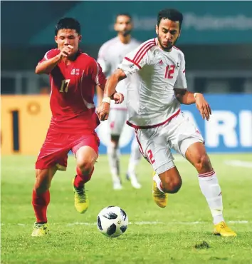  ?? AFP ?? UAE’s Khalid Al Dhanhani (right) and North Korea’s Kang Kuk-chol battle for possession during the men’s quarter-final match in Jakarta yesterday.